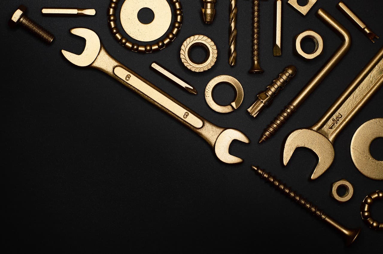 Spanners, bolts and washers laid out on black
