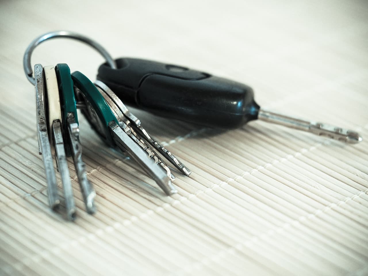 A set of car keys on a woven mat